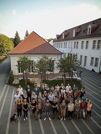 draußen: Gruppenfoto von Mitarbeiterinnen und Mitarbeitern